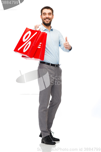 Image of smiling man with red shopping bag