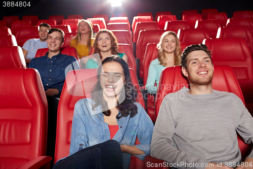 Image of happy friends watching movie in theater