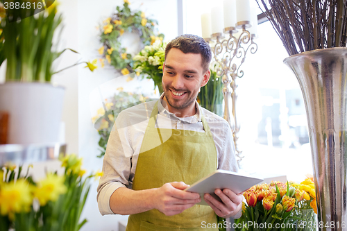 Image of man with tablet pc computer at flower shop