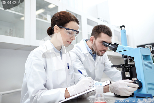 Image of young scientists making test or research in lab