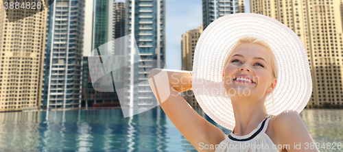 Image of happy woman enjoying summer over dubai city pool