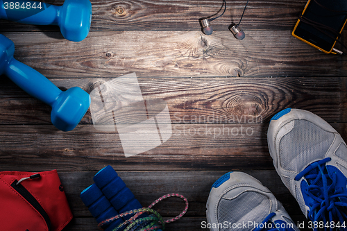 Image of Sport stuff on wooden table, top view