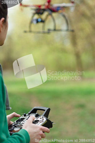 Image of Man controling a drone.