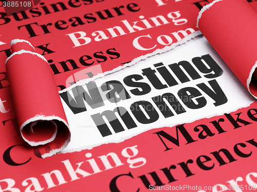 Image of Money concept: black text Wasting Money under the piece of  torn paper