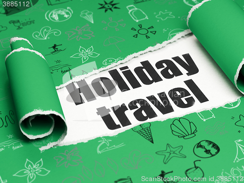 Image of Vacation concept: black text Holiday Travel under the piece of  torn paper