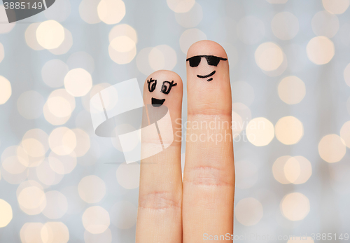 Image of close up of two fingers with smiley faces