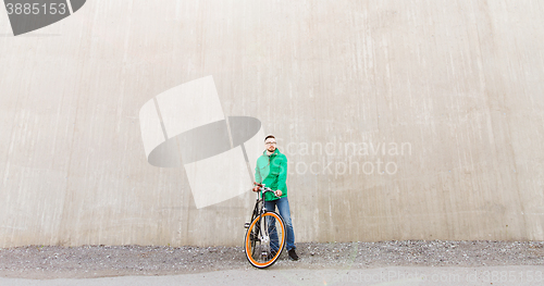 Image of happy young hipster man with fixed gear bike