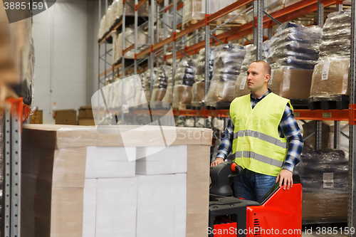 Image of man on forklift loading cargo at warehouse