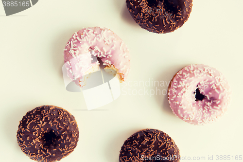 Image of close up of glazed donuts pile over white