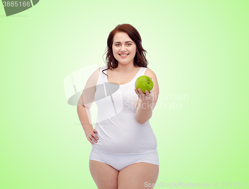 Image of happy plus size woman in underwear with apple