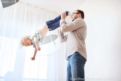 Image of father with son playing and having fun at home