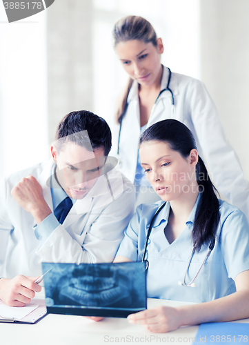 Image of group of doctors looking at x-ray