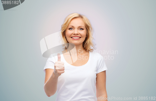 Image of smiling woman in white t-shirt showing thumbs up