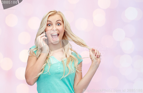 Image of smiling young woman calling on smartphone