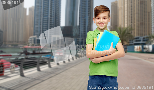 Image of happy student boy with folders and notebooks