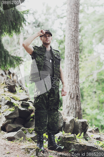 Image of young soldier or ranger in forest