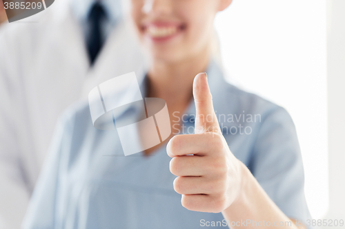 Image of close up of doctor or nurse showing thumbs 