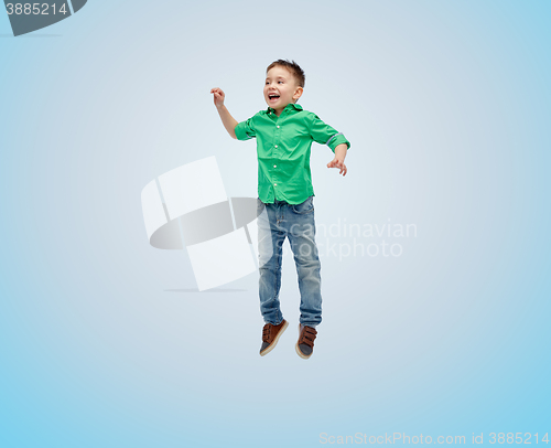 Image of happy little boy jumping in air