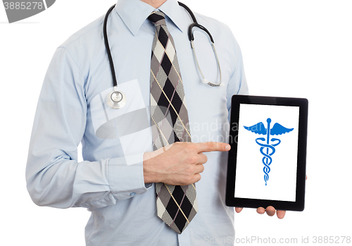 Image of Doctor holding tablet - Caduceus symbol