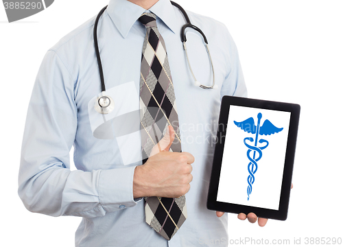 Image of Doctor holding tablet - Caduceus symbol