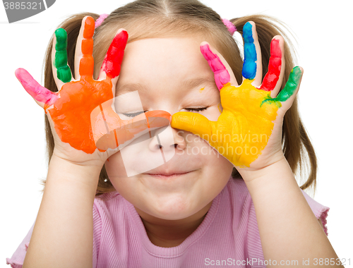 Image of Portrait of a cute girl playing with paints