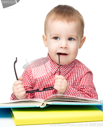 Image of Little child play with book