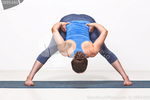 Image of Sporty fit woman practices Ashtanga Vinyasa yoga