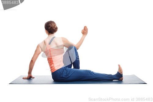 Image of woman practices yoga asana Marichyasana C