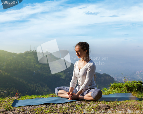 Image of Woman practice yoga asana Baddha Konasana outdoors