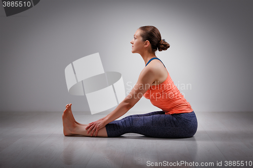 Image of Woman in Ashtanga Vinyasa yoga back bending asana