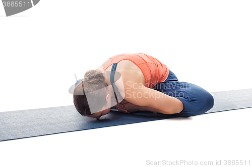 Image of Woman practices yoga asana Baddha konasana