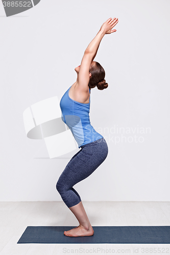 Image of Woman doing ashtanga vinyasa yoga asana Utkatasana