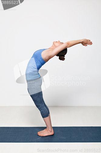 Image of Sporty fit woman practices yoga asana Anuvittasana