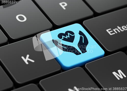 Image of Insurance concept: Heart And Palm on computer keyboard background