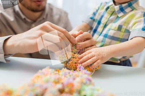 Image of father and son playing with ball clay at home