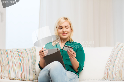 Image of happy woman with tablet pc and credit card