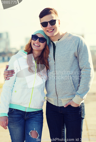 Image of happy teenage couple walking in city