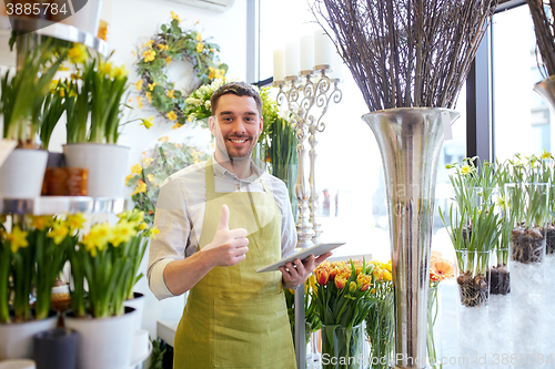 Image of man with tablet pc computer at flower shop