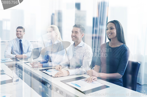 Image of smiling business people meeting in office