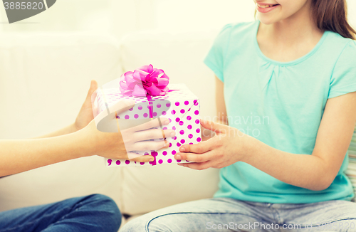 Image of close up of girls with birthday present at home