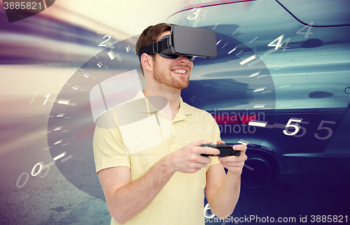 Image of man in virtual reality headset and car racing game