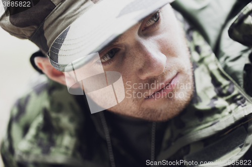 Image of close up of young soldier in military uniform