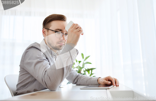 Image of businessman with smarphone at home office