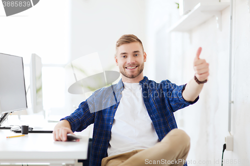 Image of happy creative man with computer at office