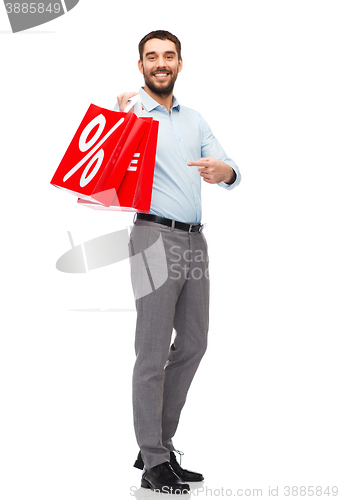 Image of smiling man with red shopping bag