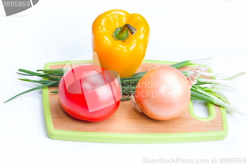 Image of onions paprica tomato vegetables on  white background