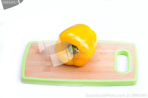 Image of yellow  paprika on wooden board