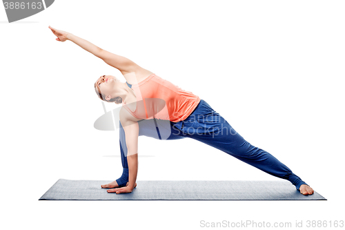 Image of Young fit woman doing Ashtanga Vinyasa Yoga asana