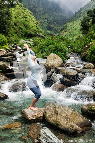 Image of Sorty fit woman doing yoga asana Utkatasana 