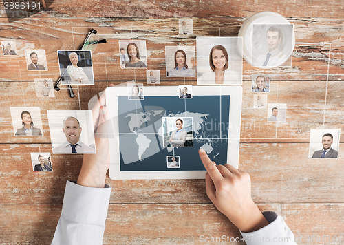 Image of close up of hands with tablet pc and network